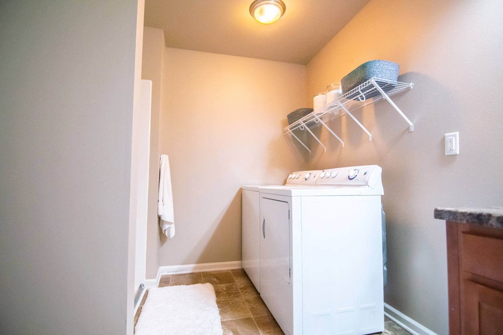 A white washing machine in a laundry room.