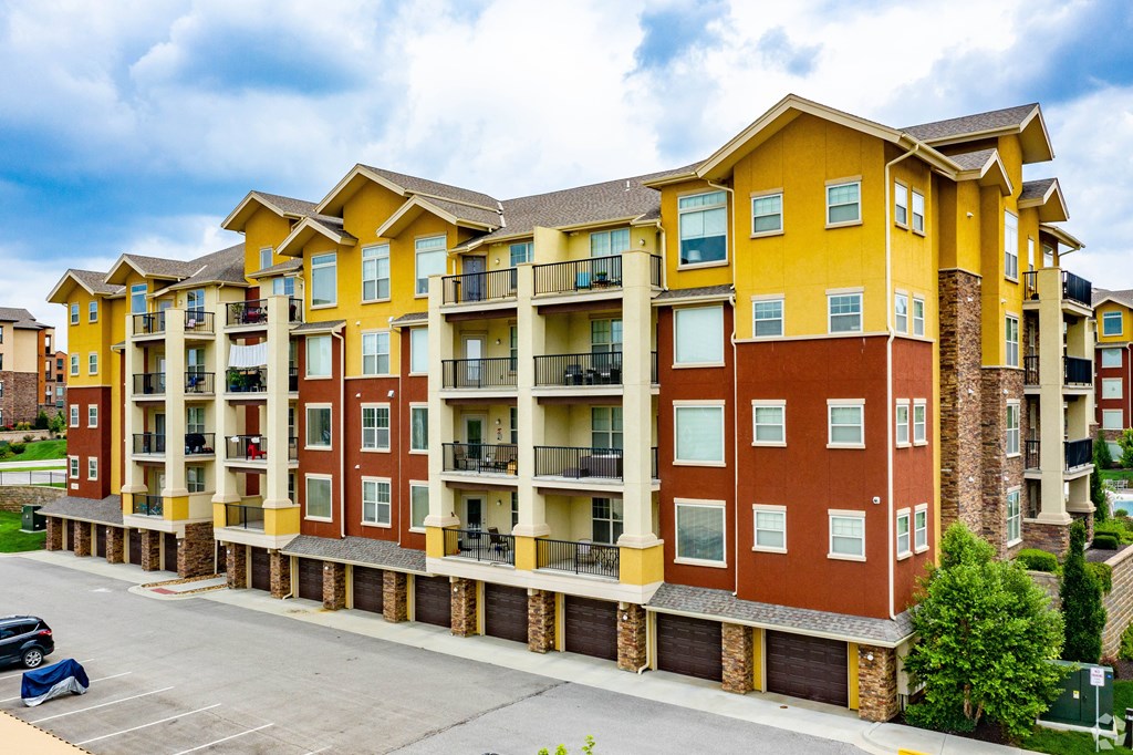 A large apartment building with multiple balconies and garages.