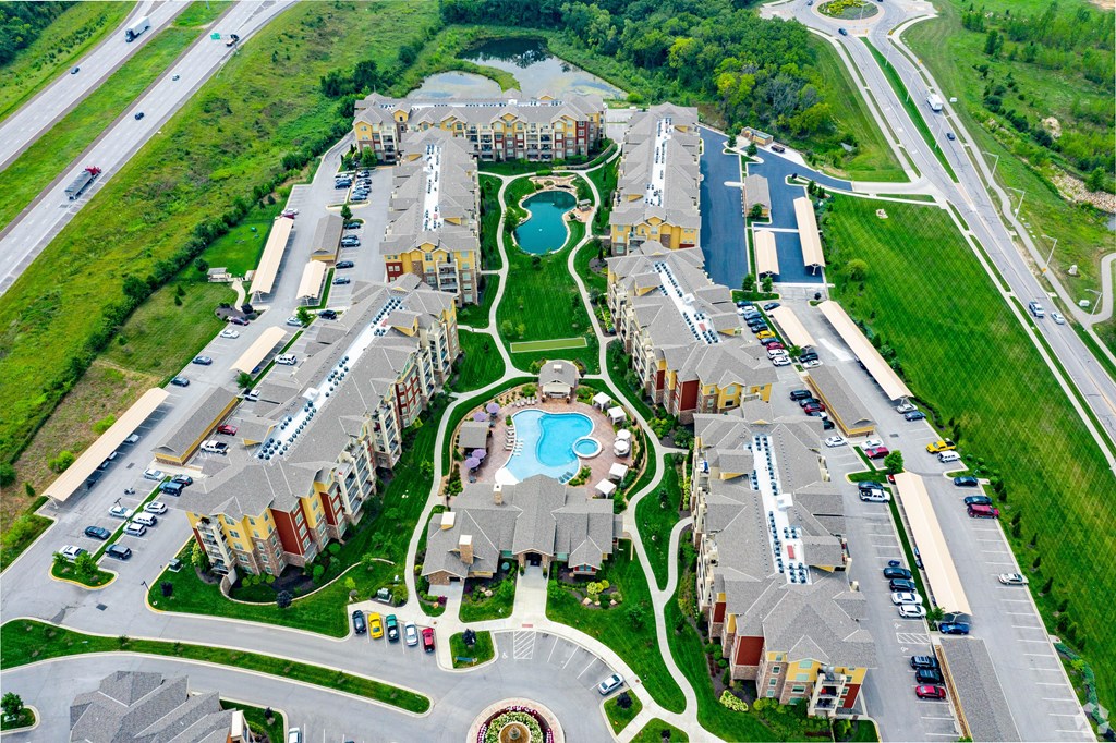 A bird's eye view of a residential complex with a swimming pool.
