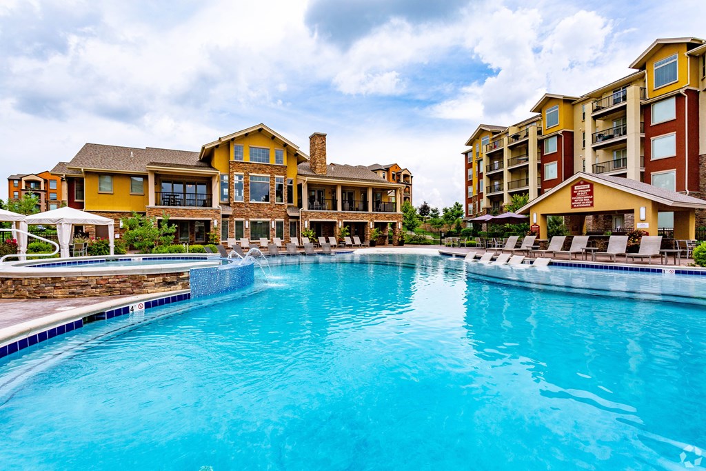 A large swimming pool in front of a resort.