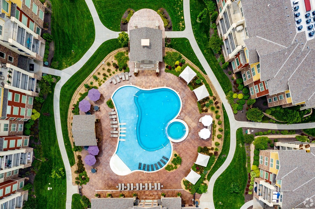An aerial view of a swimming pool surrounded by buildings.