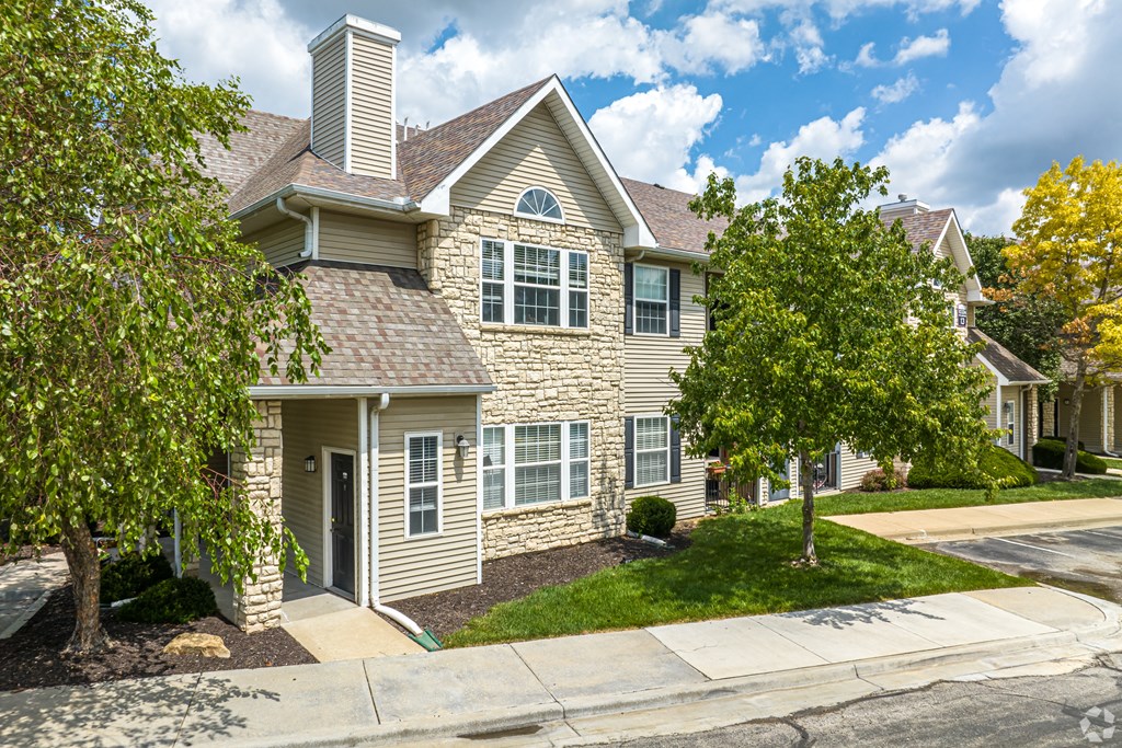 A house with a grey roof and a white chimney.