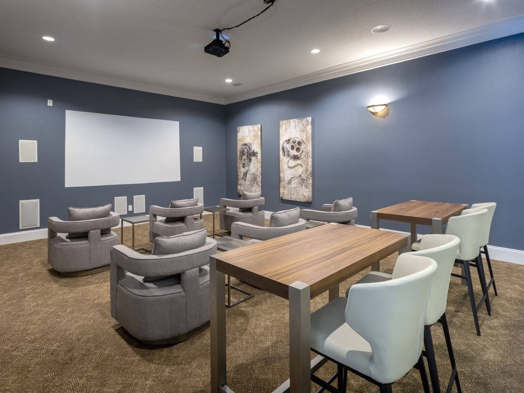 A conference room with a long table and chairs.