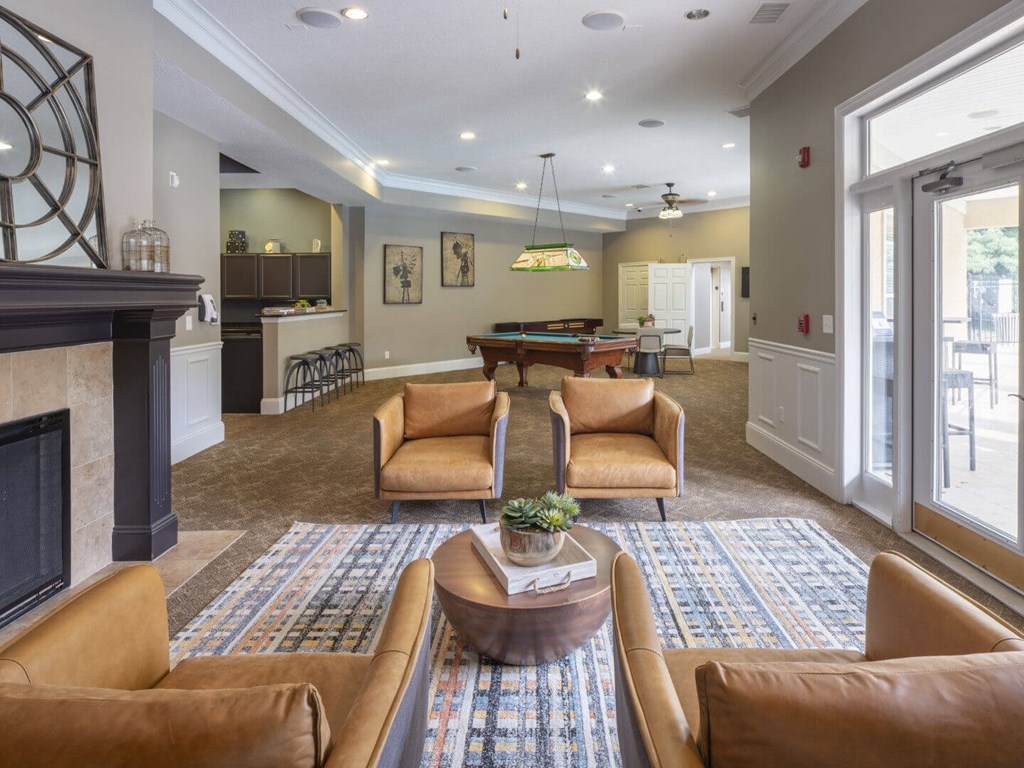 A living room with a fireplace and a pool table.