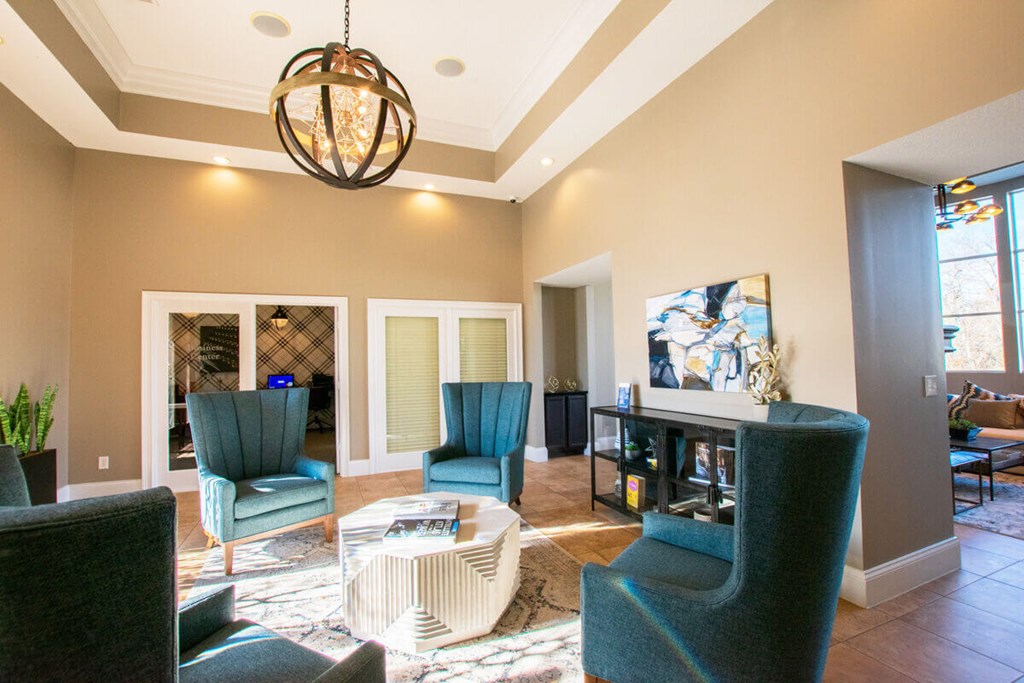 A living room with a grey sofa and a green chair.