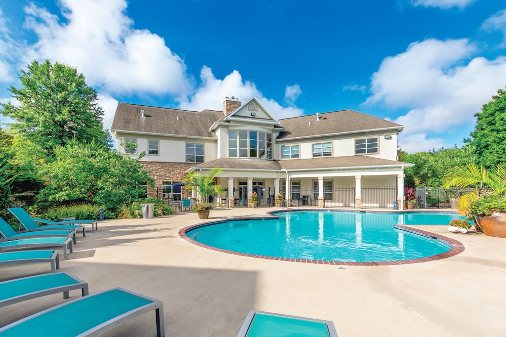 A large house with a pool in the backyard.