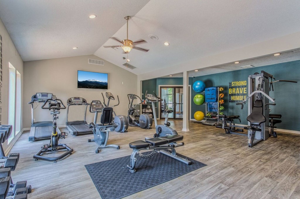 A spacious home gym with a variety of exercise equipment.