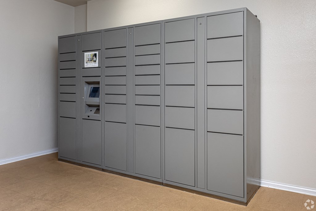 a large set of gray lockers in the corner of a room