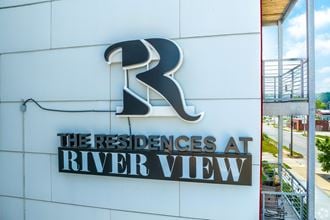 the residences at river view sign on the side of the building