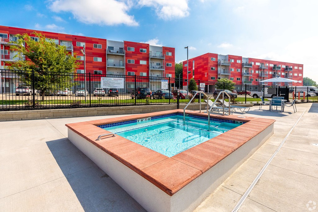 our apartments offer a swimming pool with a city building in the background