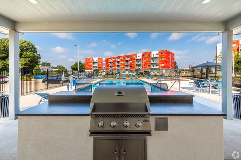 the preserve at ballantyne commons clubhouse with a gas grill and pool