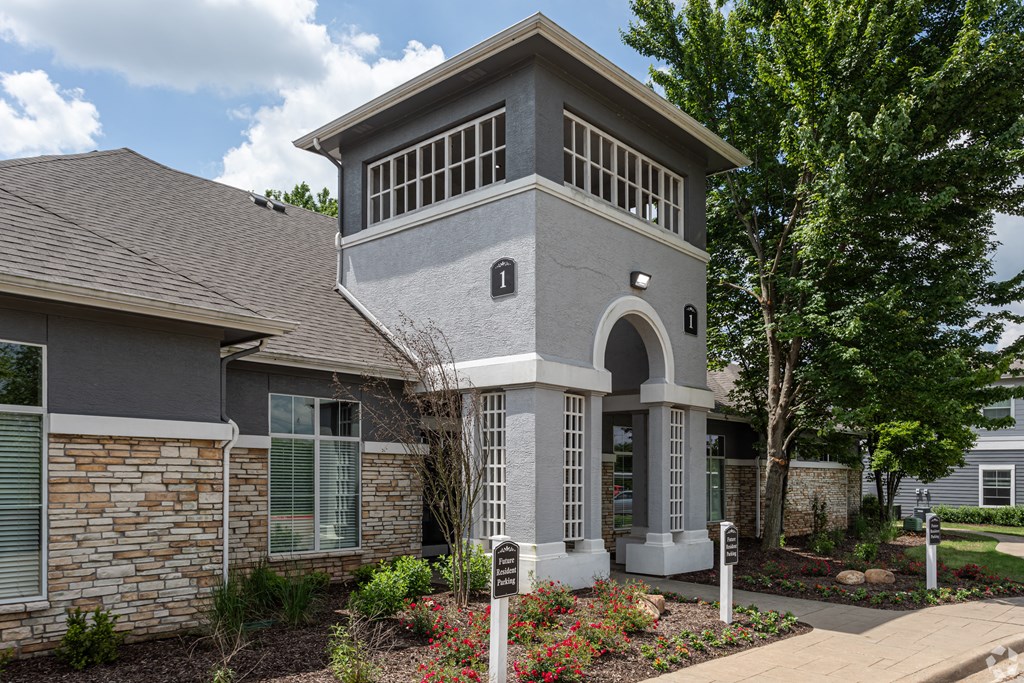 the front of a house with a walkway and landscaping