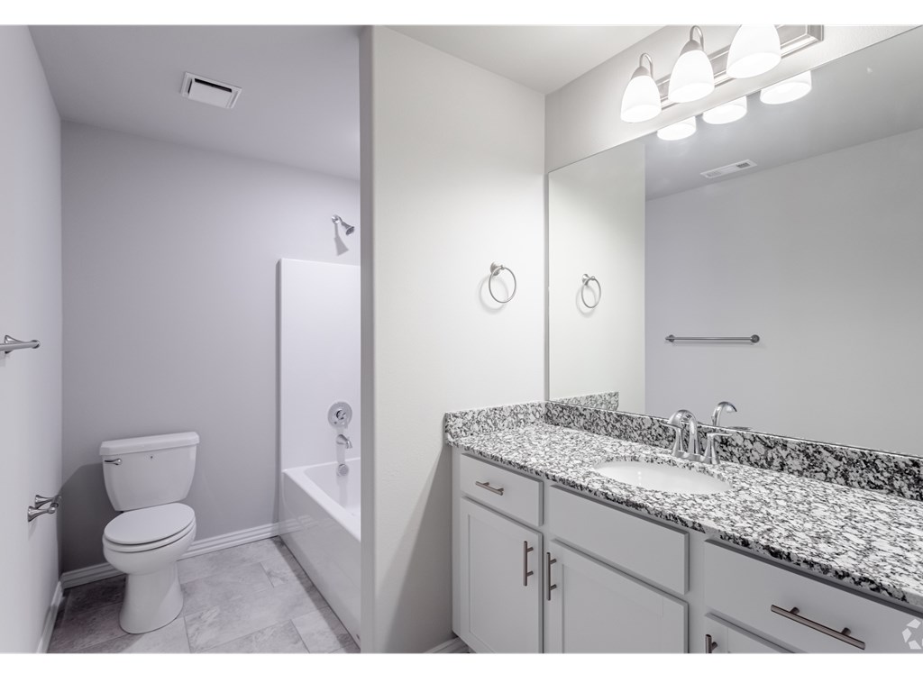 a bathroom with a toilet sink and bathtub