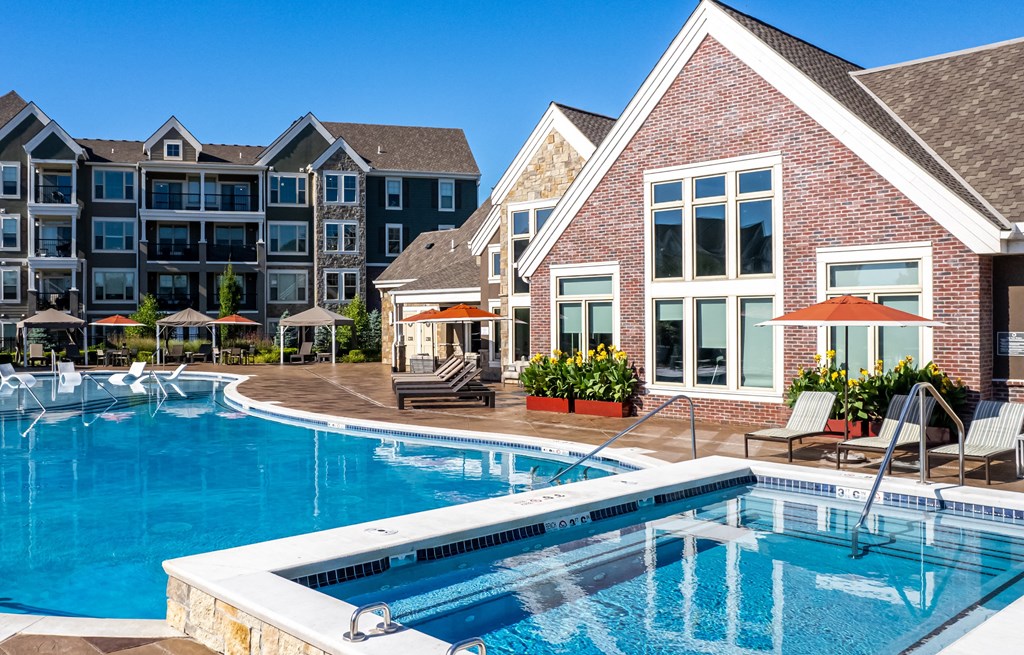 a swimming pool with an apartment building in the background  at Waterside Residences on Quivira, Lenexa, KS, 66215