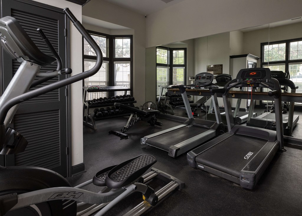 a gym with cardio equipment and weights in a building at Centennial Park Apartments, Overland Park, Kansas