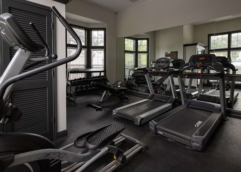 a gym with cardio equipment and weights in a building at Centennial Park Apartments, Overland Park, Kansas