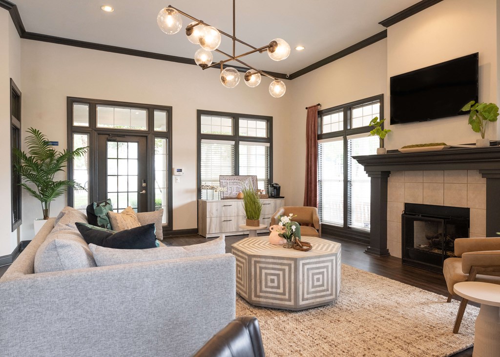 a living room with a couch and a fireplace at Centennial Park Apartments, Overland Park