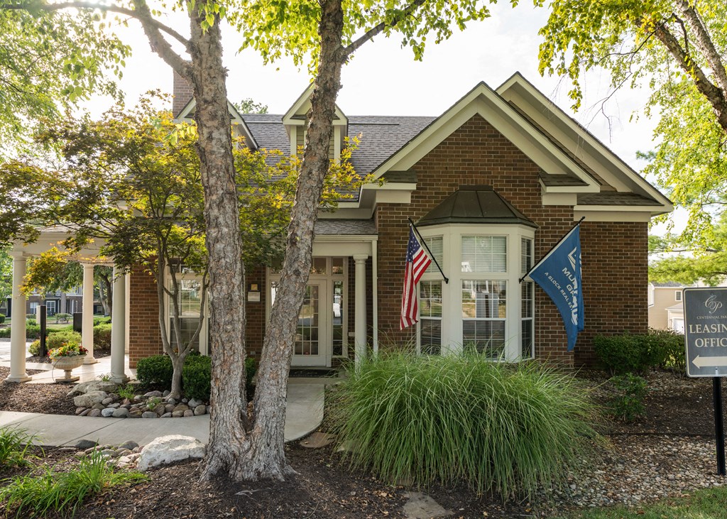 a building with an flag in front of it a building with an flag in front of itat Centennial Park Apartments, Overland Park, KS
