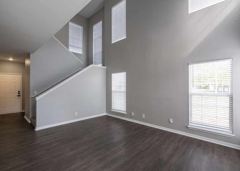 an empty living room with wood floors and white walls at Centennial Park Apartments, Overland Park, 66213
