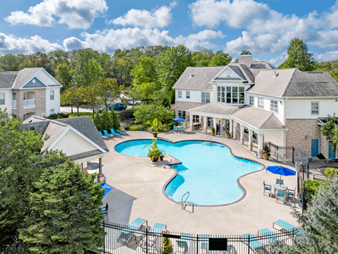 A large house with a pool in the backyard.