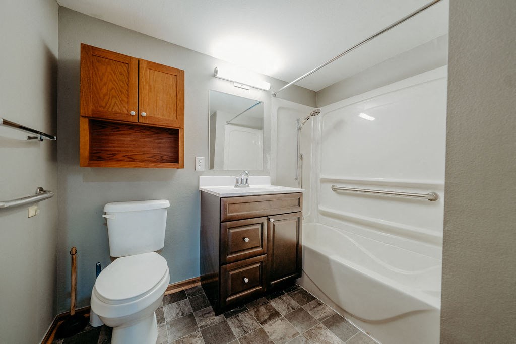 a bathroom with a toilet sink and a shower