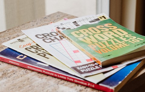 a stack of crossword puzzles on a table