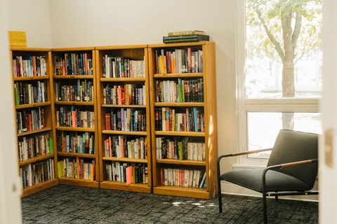 a chair and bookcase in a room