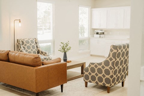 a living room with two chairs and a couch