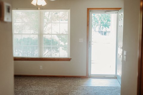 an empty room with a door and a window