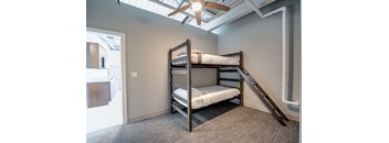 a bunk bed in a room with a ceiling fan