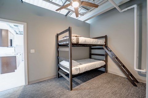 a bunk bed in a room with a ceiling fan