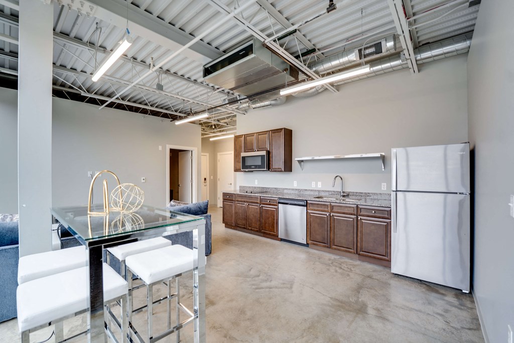 a kitchen with white appliances and a glass table