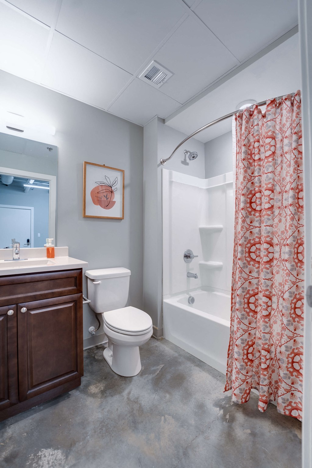 a bathroom with a shower curtain and a toilet and a sink