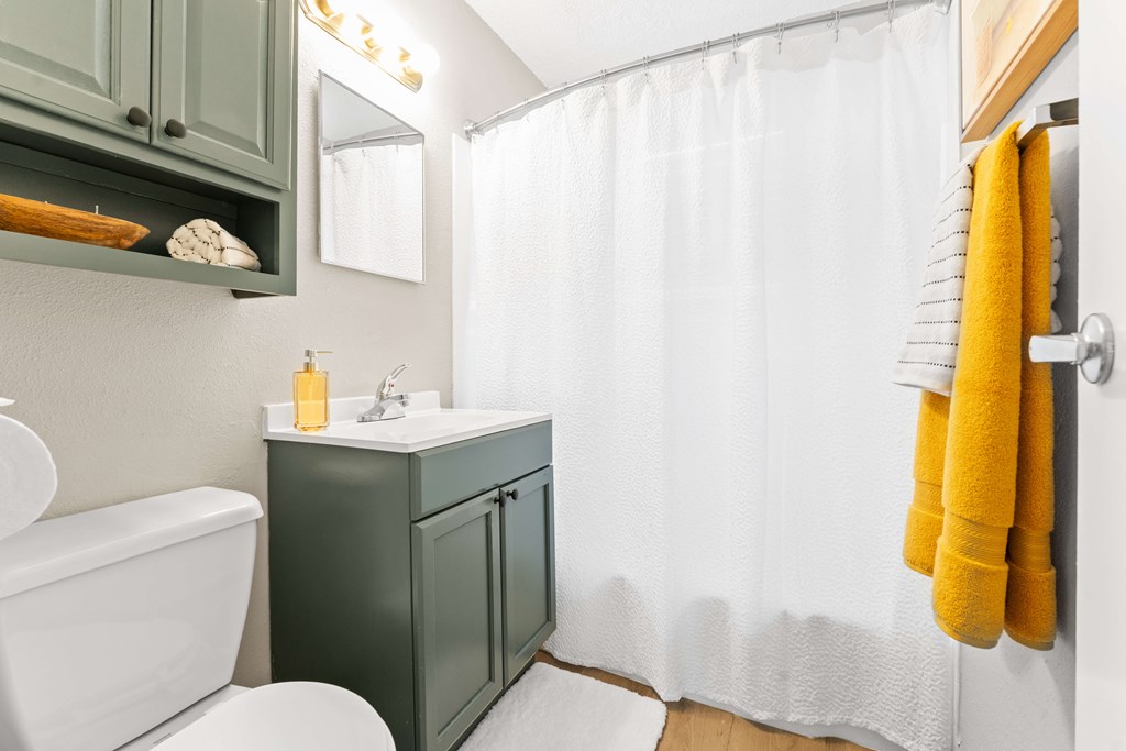 A white toilet sits next to a sink in a bathroom.