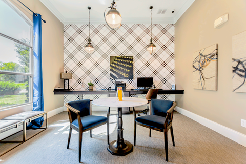 A dining room with a table and chairs.