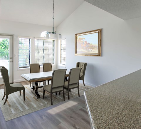 A dining room with a table and chairs.