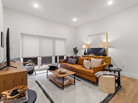 A modern living room with a brown sofa and a television.
