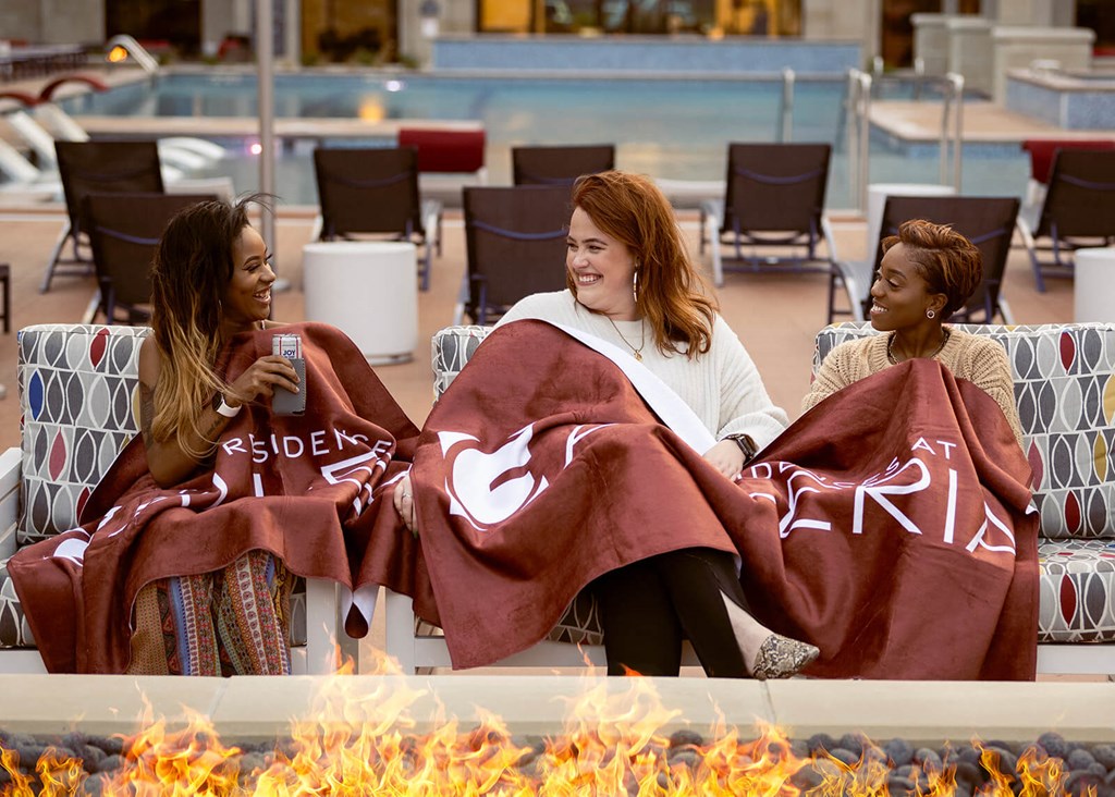 Friends by the fire pit at The Residences at Galleria, Overland Park