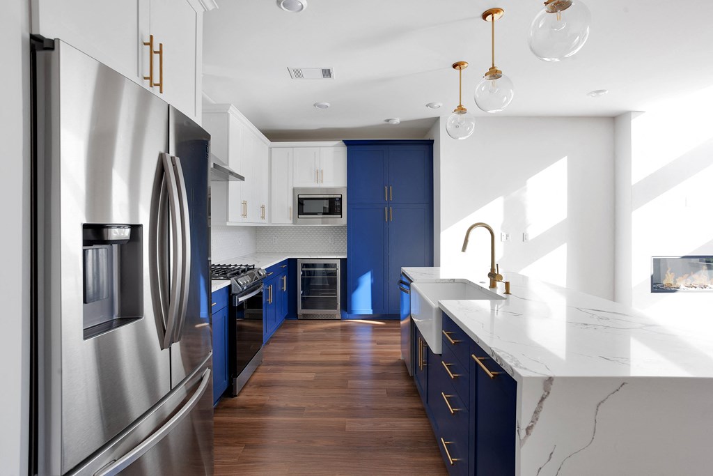 Kitchen with stainless steel appliances and blue cabinets at 44 Washington, Kansas City, MO