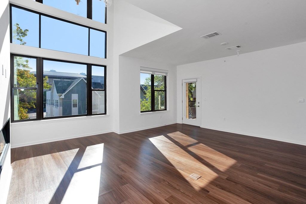 Empty living room with large windows at 44 Washington, Kansas City, Missouri