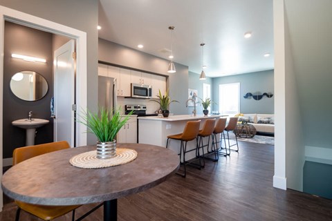 A modern kitchen with a round table and chairs.