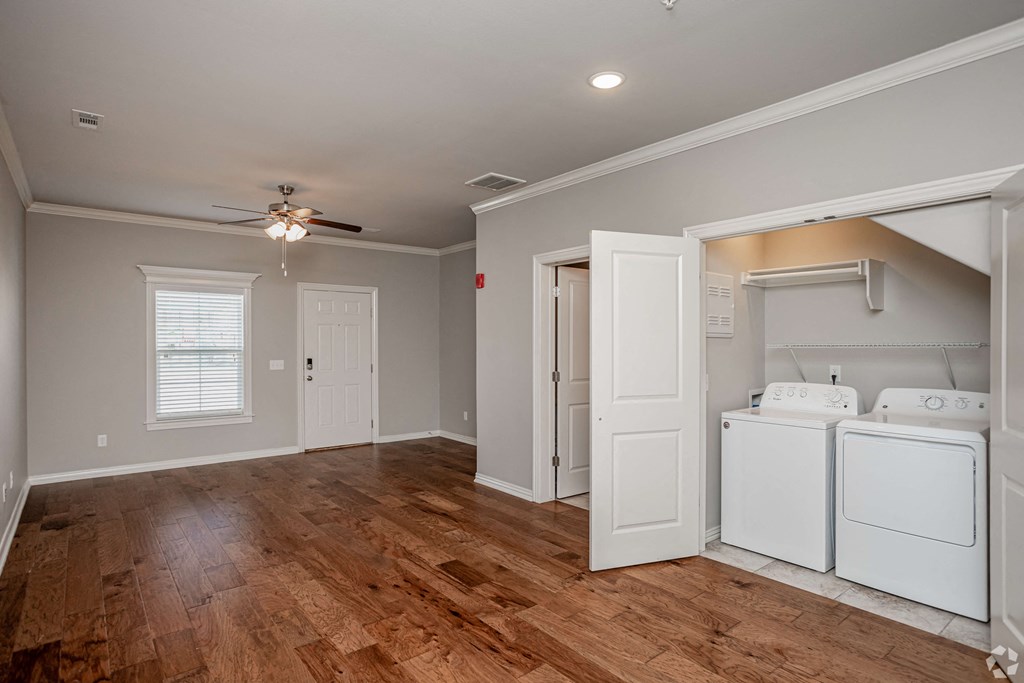 a laundry room with washer and dryer and a ceiling fan