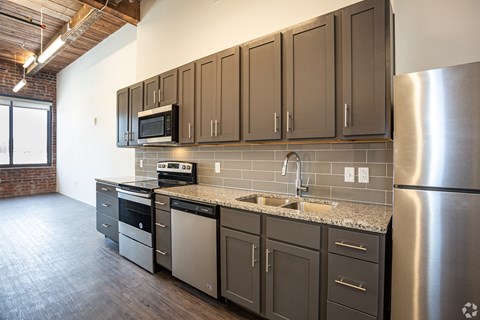 a kitchen with stainless steel appliances and brown cabinets