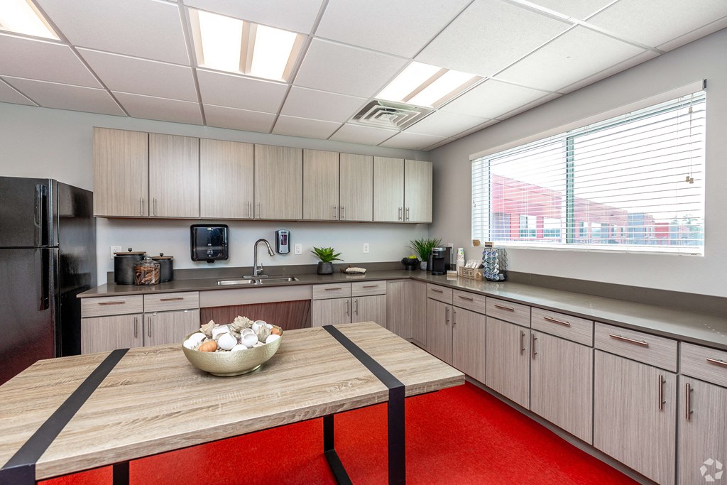 a kitchen with wooden cabinets and a table with a bowl of eggs