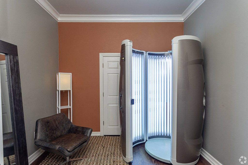 a room with a heater and a chair and a window