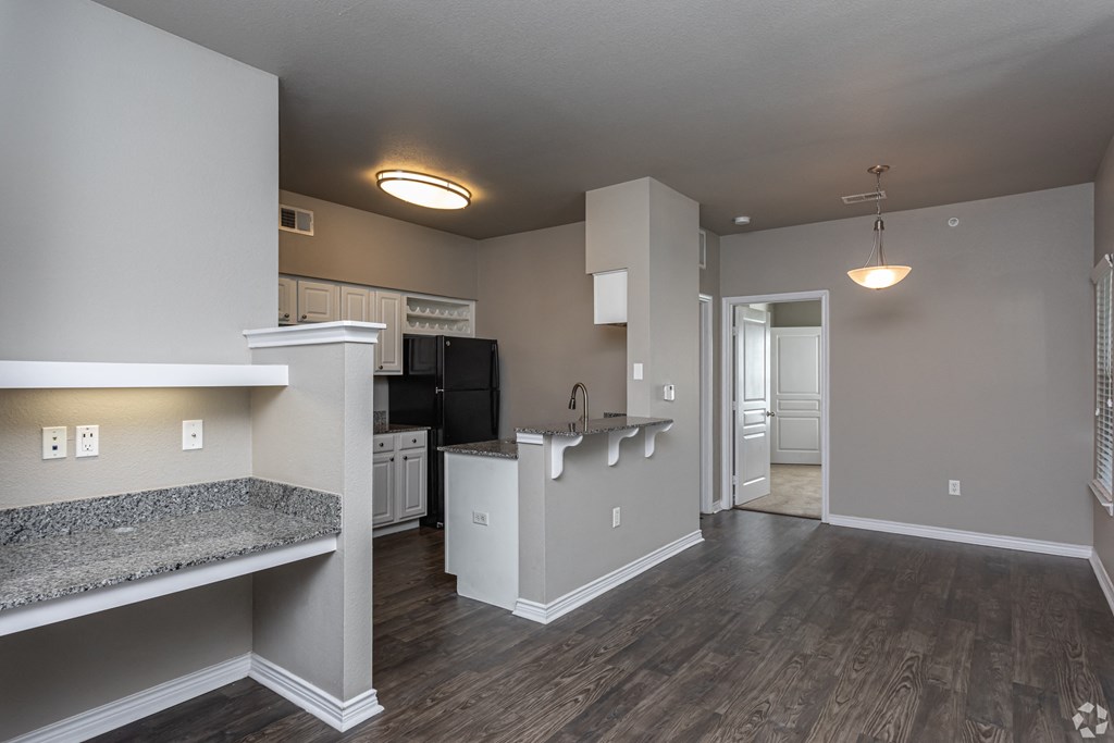a view of a kitchen and a living room in an empty apartment