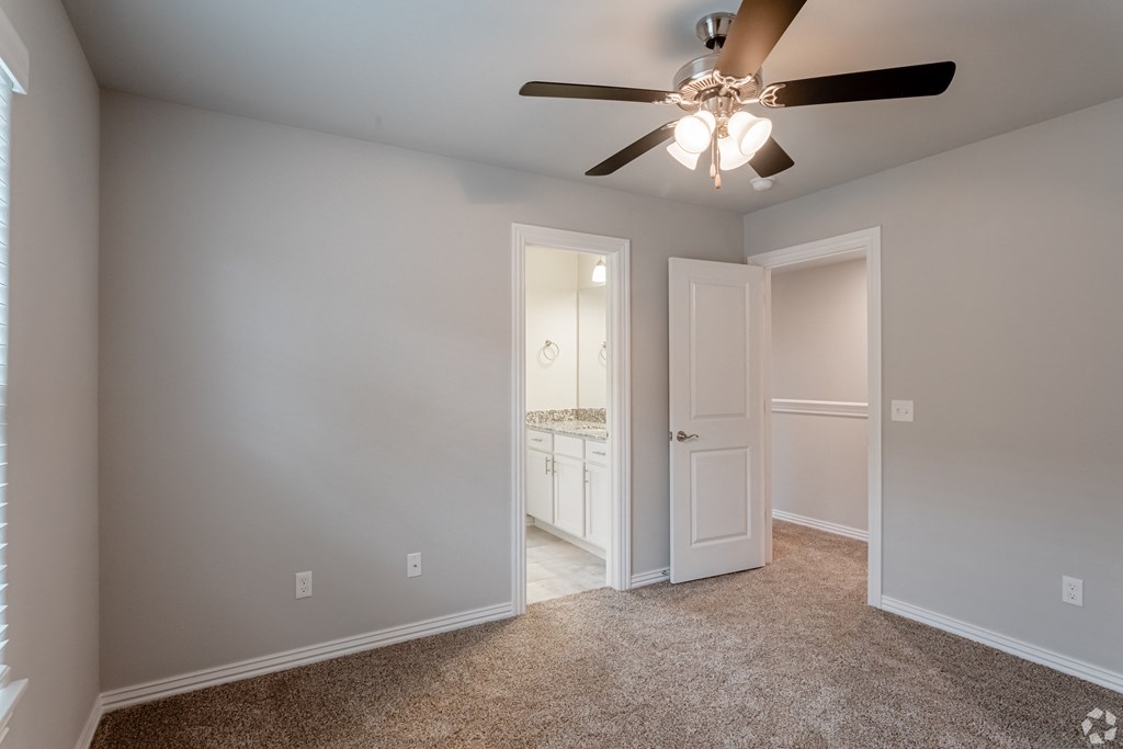 a bedroom with a ceiling fan
