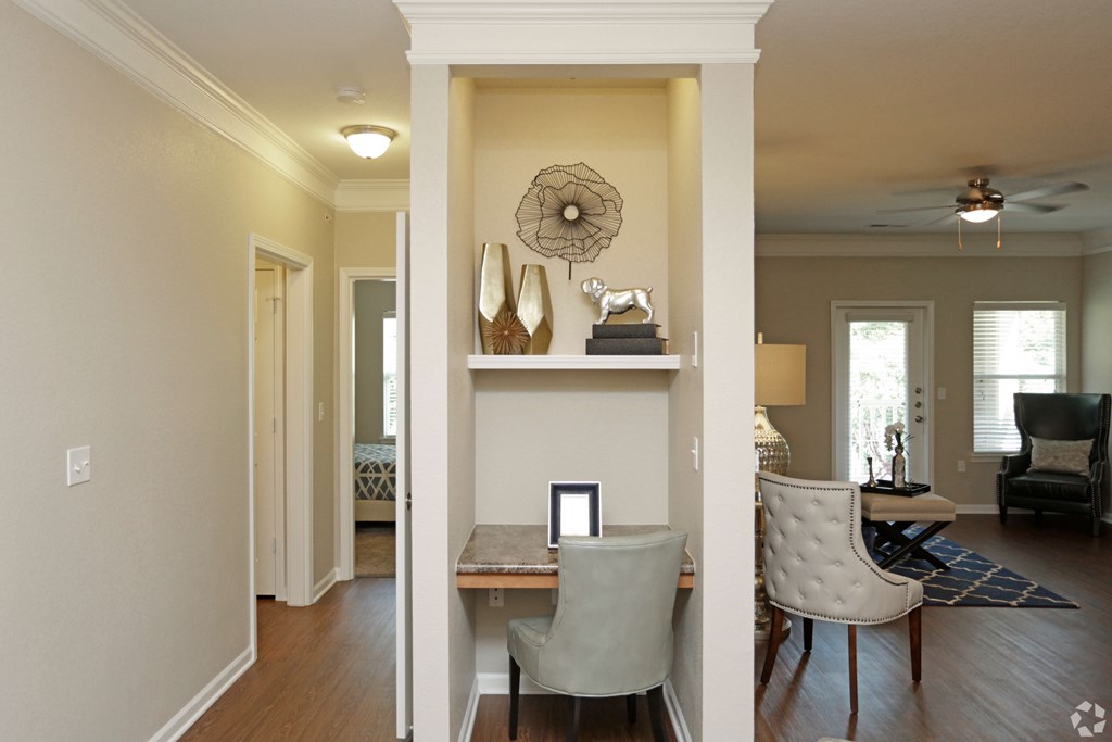 A dining room with a table and chairs.