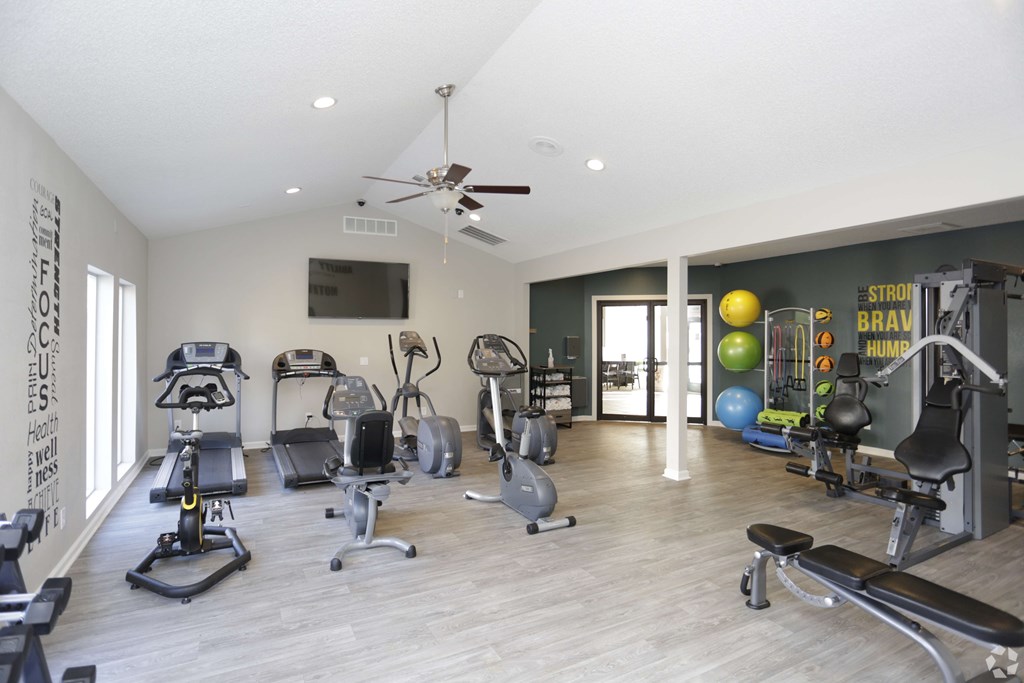 A spacious home gym with a variety of exercise equipment.