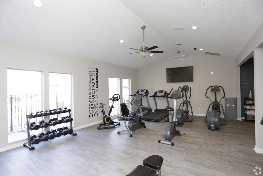 A spacious home gym with a variety of exercise equipment.